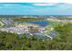 An aerial view of the community with tennis courts, a lake and a golf course at 12470 Wellen Golf St # 203, Venice, FL 34293