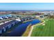 Aerial view of community featuring golf course, ponds and pool on a sunny day at 12470 Wellen Golf St # 203, Venice, FL 34293