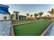 Manicured bocce ball courts near the clubhouse surrounded by lush landscaping offer a relaxing outdoor activity at 12470 Wellen Golf St # 203, Venice, FL 34293