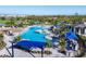 Aerial view of community resort-style pool, landscaping, and multiple buildings for recreation at 12470 Wellen Golf St # 203, Venice, FL 34293