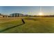 Beautiful image of a golf course with a golf bag in the foreground at 12470 Wellen Golf St # 203, Venice, FL 34293