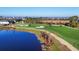 Aerial view of lush, manicured golf course with sand traps, ponds, and new construction homes at 12470 Wellen Golf St # 203, Venice, FL 34293