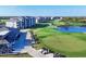 Scenic aerial view of a well-maintained golf course with modern condos overlooking the course at 12470 Wellen Golf St # 203, Venice, FL 34293