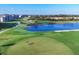 A well-maintained golf course with a scenic water hazard for an added challenge at 12470 Wellen Golf St # 203, Venice, FL 34293