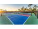 Brightly colored pickleball courts provide recreational fun in a well-maintained outdoor setting at 12470 Wellen Golf St # 203, Venice, FL 34293