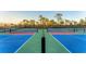 Well-maintained pickleball courts offer an active lifestyle with colorful surfaces and professional nets at 12470 Wellen Golf St # 203, Venice, FL 34293