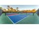 A view of the community pickleball courts with colorful new surface surrounded by a security fence at 12470 Wellen Golf St # 203, Venice, FL 34293