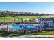 Resort-style pool with lounge chairs and umbrellas overlooks the golf course and lush landscaping at 12470 Wellen Golf St # 203, Venice, FL 34293