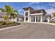 Close up of the pro shop with modern architecture, a drive up area and tropical landscaping at 12470 Wellen Golf St # 203, Venice, FL 34293