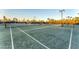 Wide angle view of the community tennis courts with new surface, benches and nets at 12470 Wellen Golf St # 203, Venice, FL 34293