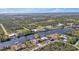 Aerial view of property with canal, dock and lush landscape at 13449 Palau Cir, Port Charlotte, FL 33953