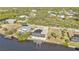 Aerial view of waterfront home with pool and solar panels at 13449 Palau Cir, Port Charlotte, FL 33953