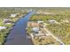 Aerial view of waterfront home with pool and solar panels at 13449 Palau Cir, Port Charlotte, FL 33953