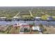 Aerial view of waterfront home with canal access and lush landscaping at 13449 Palau Cir, Port Charlotte, FL 33953