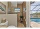 Walk-in shower with glass enclosure and pool view at 13449 Palau Cir, Port Charlotte, FL 33953