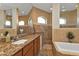 Elegant bathroom with a soaking tub, walk-in shower, and granite vanity at 13449 Palau Cir, Port Charlotte, FL 33953