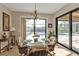 Breakfast nook with wicker chairs, glass table, and view of pool and canal at 13449 Palau Cir, Port Charlotte, FL 33953