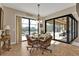 Bright breakfast nook with a glass-top table and wicker chairs, overlooking the pool at 13449 Palau Cir, Port Charlotte, FL 33953