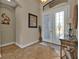 Bright and airy foyer with tile flooring, a glass-paned door and a console table at 13449 Palau Cir, Port Charlotte, FL 33953