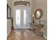 Elegant entryway featuring a large circular mirror and a wicker console table at 13449 Palau Cir, Port Charlotte, FL 33953