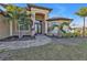 Welcoming front entry with a paved walkway and lush landscaping at 13449 Palau Cir, Port Charlotte, FL 33953