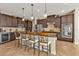 Modern kitchen with dark cabinetry, granite counters, and stainless steel appliances at 13449 Palau Cir, Port Charlotte, FL 33953