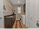 Laundry room with granite countertop and built-in shelving at 13449 Palau Cir, Port Charlotte, FL 33953