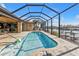 Relaxing pool with screened enclosure, canal views, and dock at 13449 Palau Cir, Port Charlotte, FL 33953