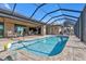 Inviting pool area with covered lanai, ample seating, and a tranquil atmosphere at 13449 Palau Cir, Port Charlotte, FL 33953