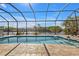 Screened-in pool with canal views and ample patio space at 13449 Palau Cir, Port Charlotte, FL 33953