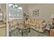 Cozy sitting area with a floral patterned sofa and a glass-top coffee table at 13449 Palau Cir, Port Charlotte, FL 33953