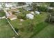 Aerial view of a property with a house, shed, and spacious yard at 1713 Belvidere Rd, Englewood, FL 34223