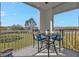 Private balcony with table and chairs, overlooking a green space at 2061 Willow Hammock Cir # 204, Punta Gorda, FL 33983