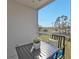 Relaxing balcony with table, chairs, and leafy view at 2061 Willow Hammock Cir # 204, Punta Gorda, FL 33983