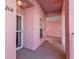 Building entrance with pink walls and white door at 2061 Willow Hammock Cir # 204, Punta Gorda, FL 33983