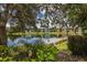 Scenic view of lakefront homes with lush landscaping at 2061 Willow Hammock Cir # 204, Punta Gorda, FL 33983