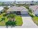 Aerial view of a waterfront home with a large backyard and paved driveway at 2199 El Cerito Ct, Punta Gorda, FL 33950