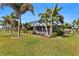 Lush landscaping surrounds a screened-in patio, creating a relaxing outdoor space at 2199 El Cerito Ct, Punta Gorda, FL 33950