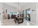 Bright dining room with wood table and chairs, large windows, and stylish light fixture at 2199 El Cerito Ct, Punta Gorda, FL 33950