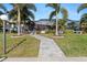 Inviting walkway leads to a charming home with tropical landscaping at 2199 El Cerito Ct, Punta Gorda, FL 33950