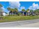 Landscaped backyard with lush lawn and palm trees at 25223 Keygrass Ct, Punta Gorda, FL 33955