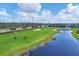 Aerial view of golfers on the course near water features at 25223 Keygrass Ct, Punta Gorda, FL 33955