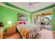 Main bedroom with green walls, king bed, and private balcony at 255 W End Dr # 2412, Punta Gorda, FL 33950