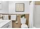 Clean bathroom with a white toilet and brown tile at 330 45Th S St, St Petersburg, FL 33711