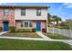 Brick townhome with blue doors and landscaped yard at 3335 Purple Martin Dr # 1, Punta Gorda, FL 33950