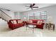 Living room with red couches, coffee table, and tiled floor at 3335 Purple Martin Dr # 1, Punta Gorda, FL 33950