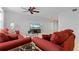 Living room with red couches and tile floors at 3335 Purple Martin Dr # 1, Punta Gorda, FL 33950