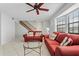 Living room with staircase and red couches at 3335 Purple Martin Dr # 1, Punta Gorda, FL 33950