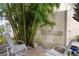 Private patio with seating, tall plants, and a wooden privacy screen at 3335 Purple Martin Dr # 1, Punta Gorda, FL 33950