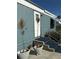 Front entrance of the manufactured home with stairs and potted plants at 4156 Bardot Rd, Port Charlotte, FL 33953